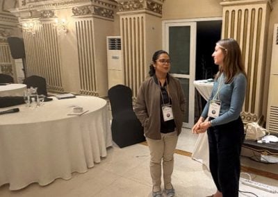 A reception hall filled with scientists engaging in lively academic discussion.