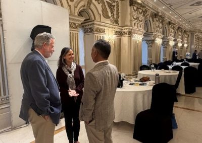 A reception hall filled with scientists engaging in lively academic discussion.